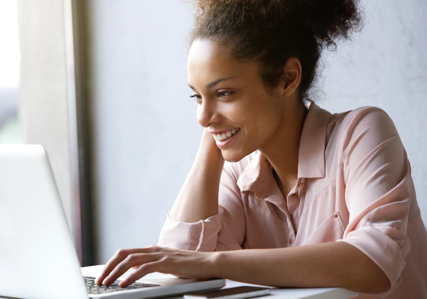 A patient smiling while reviewing financial options online